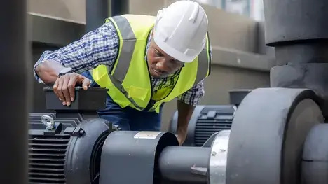 A technician attempting to fix a machine