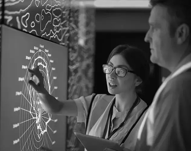 A woman explaining technical solutions on a digital board