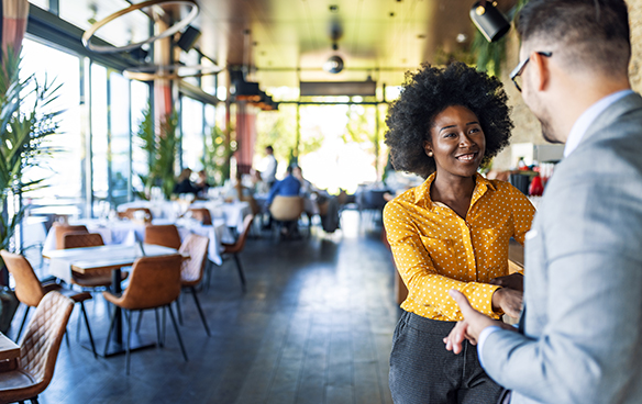 Photo of colleagues discussing outsourcing learning and development in a restaurant setting