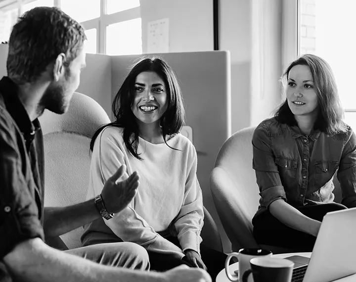 Photo of coworkers discussing managed learning services